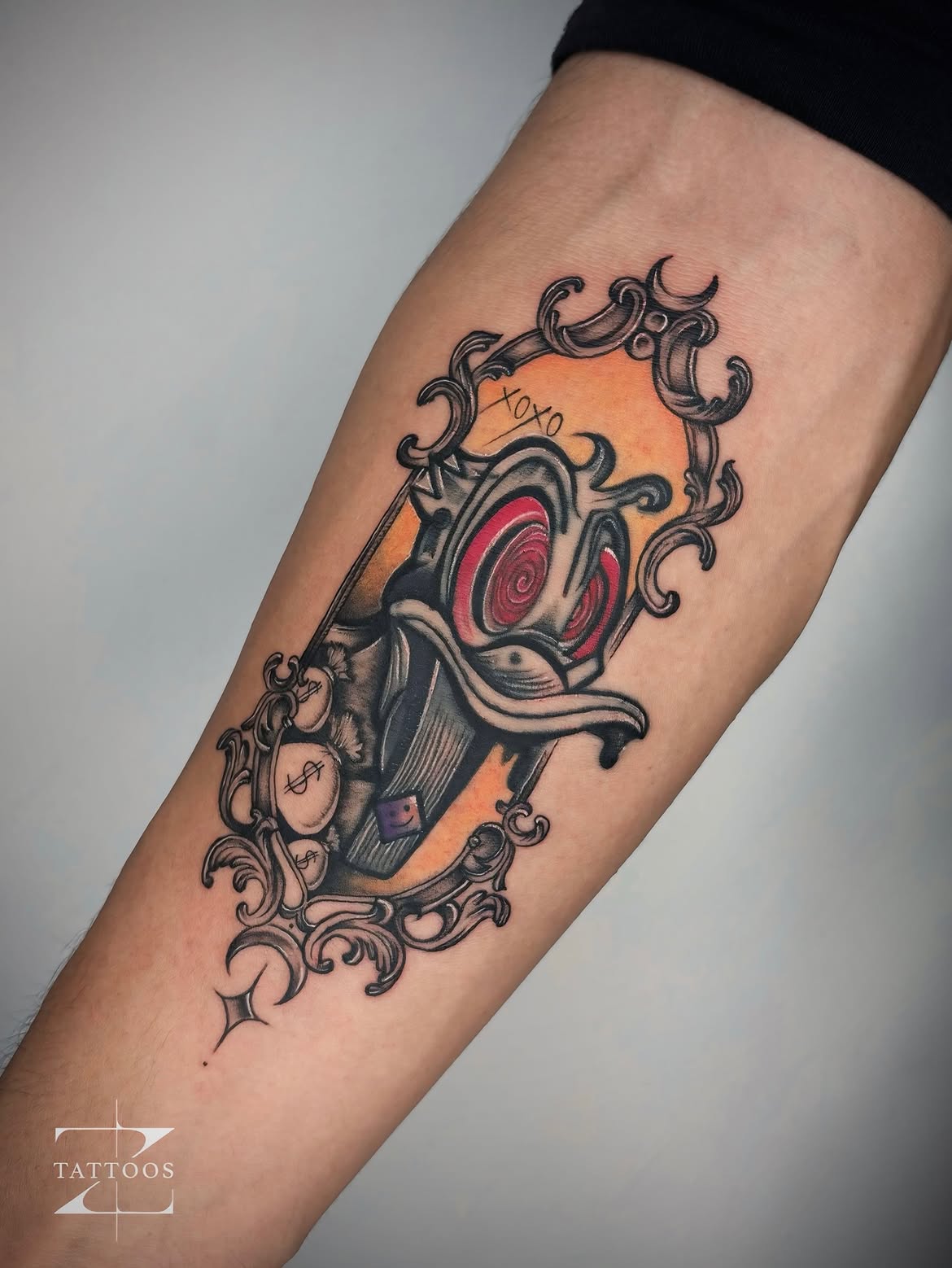 Vibrant ornamental cover-up with warm tones and baroque frame detail by ZTattoo.