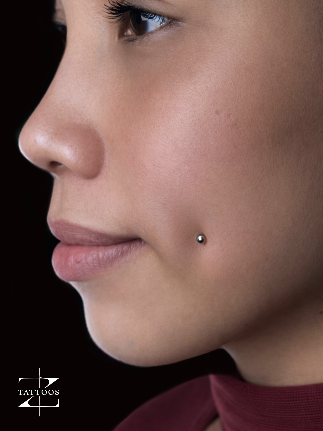 Clean nostril piercing with a small titanium stud.
